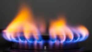 Why does the gas on the stove burn orange, red or yellow?