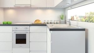 White electric built-in ovens in the interior of the kitchen