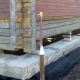 Replacement and strengthening of the foundation under a standing wooden house